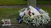 Flowers and candles left at home where three children died in fire