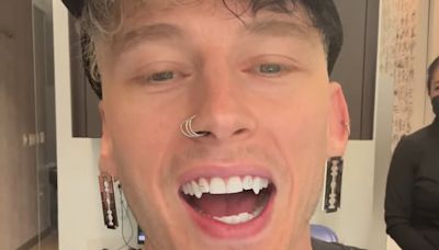 Machine Gun Kelly unveils his new diamond-studded VAMPIRE FANGS