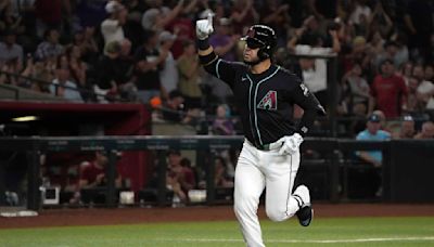 Eugenio Suarez homers, drives in 3 runs to help the Diamondbacks rally past the Braves, 7-5