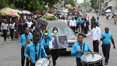 Hundreds mourn gang killings of a Haitian mission director and a young American couple