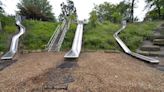 Woman claims she broke vertebrae on giant slides at Erie's Frontier Park. She is suing