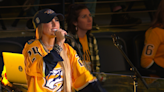 Who's the Nashville artist drinking beer from catfish at Predators playoff game?