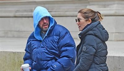 Adam Sandler bundles up in £700 padded jacket while wife Jackie keeps warm in a £1,500 coat as they enjoy a stroll around chilly London