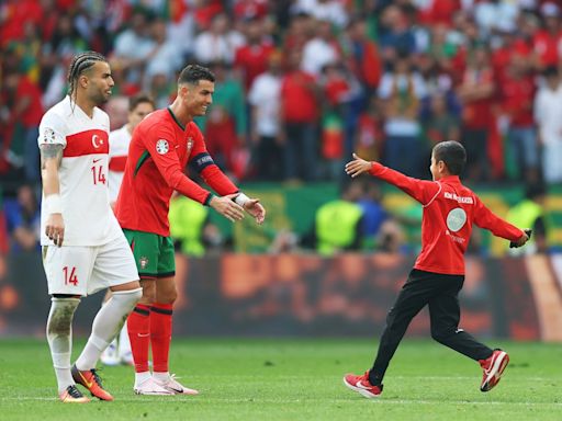 Pitch invaders, lookalikes and a steward’s slide tackle: Ninety minutes in the presence of Cristiano Ronaldo