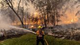 Lightning and a burning car pushed into a gully are blamed for wildfires scorching the West