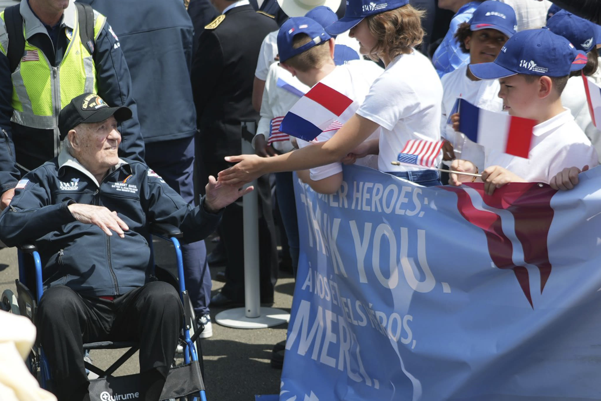 French children hail D-Day veterans as heroes as they arrive in Normandy for anniversary events