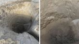 Mystery as nine-foot deep hole dug on popular tourist beach, as authorities raise fears of fatal collapse