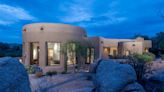 Built into rocks and over a stream, romantic home for sale wows in Arizona. See it