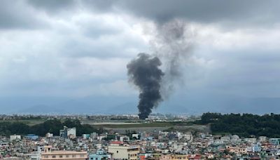 A plane slips off the runway and crashes in Nepal, killing 18 passengers and injuring the pilot