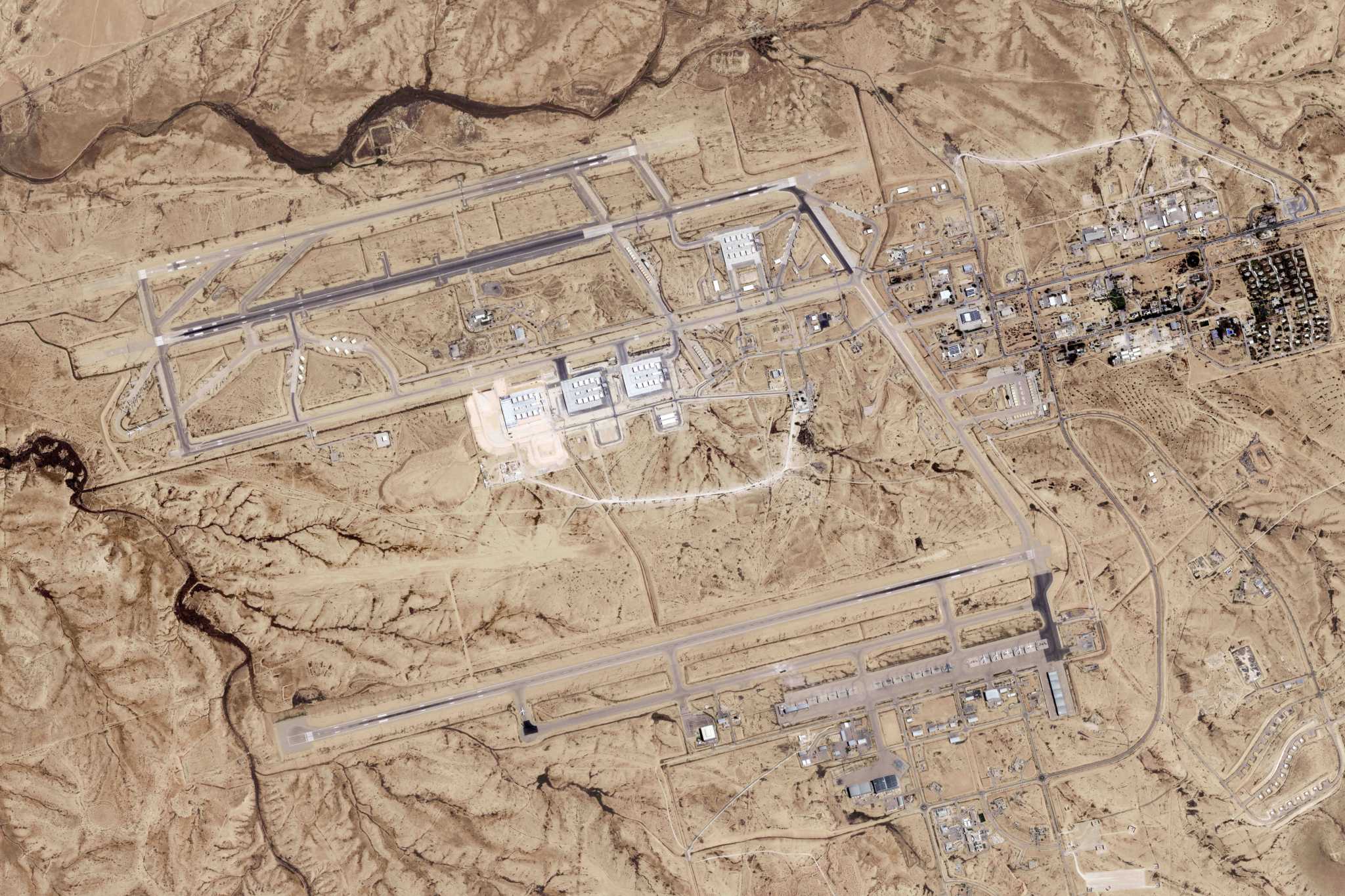 Satellite image analyzed by AP shows damage after Iranian attack on Israeli desert air base