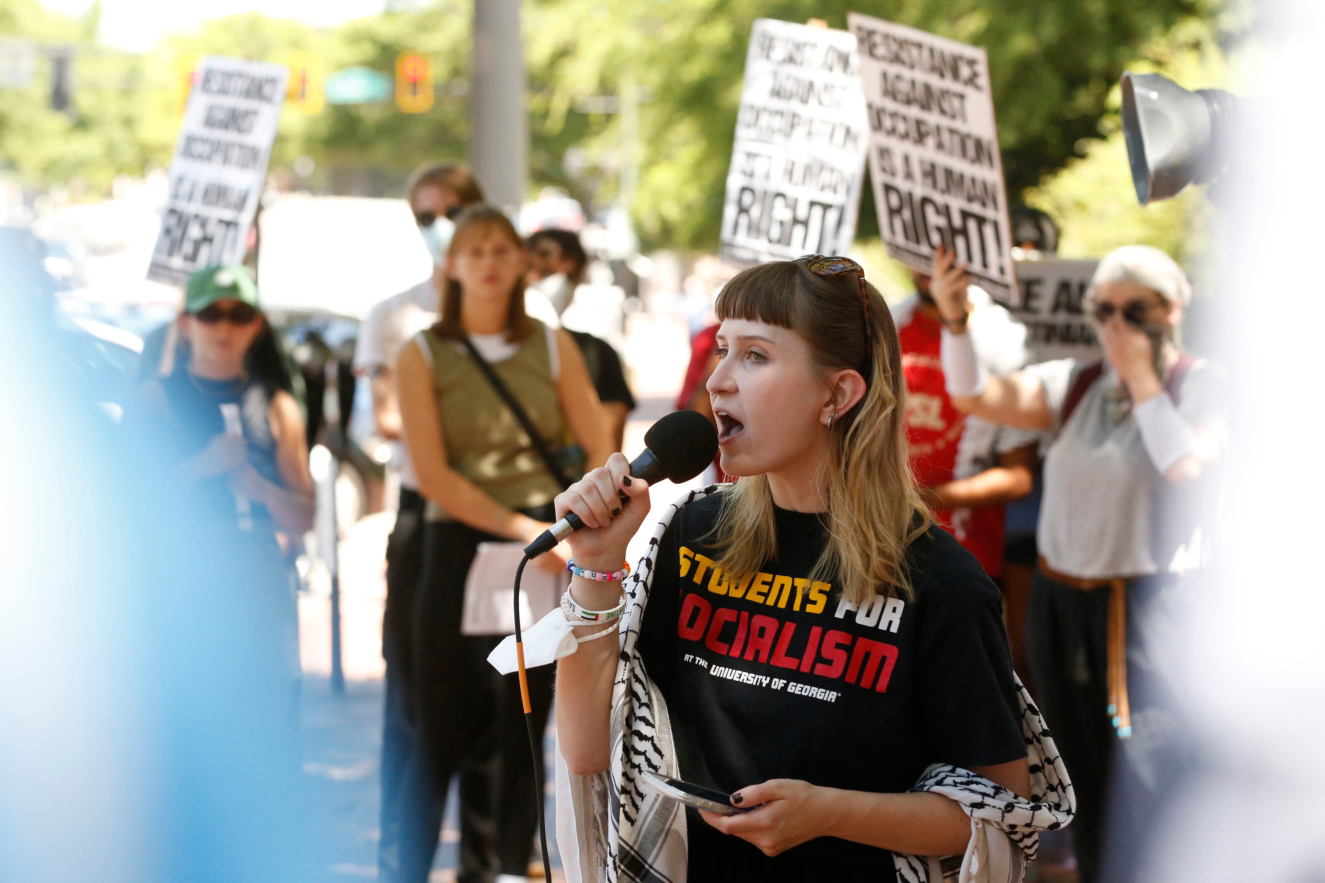 Protest against Israel occurs with backdrop of graduating UGA students taking pics at Arch