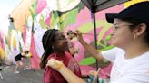 Appleton students paint a 100-foot mural to spread a message of love and connect with the community