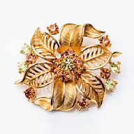 Pins in the shape of flowers or featuring floral designs. Can add a touch of natural beauty and femininity to any outfit.