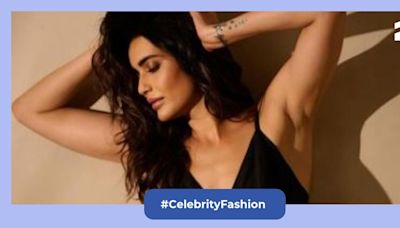 Karishma Tanna serving major looks in a black satin crop top and light blue denim