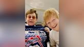 Ed Sheeran and Elton John swap Christmas presents and pull crackers as they watch Ipswich Town match