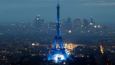 Eiffel Tower glows on rainy night, but many fans can't see opening ceremony