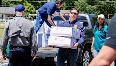 Florida Gov. DeSantis visits Tallahassee school to help distribute supplies after storm