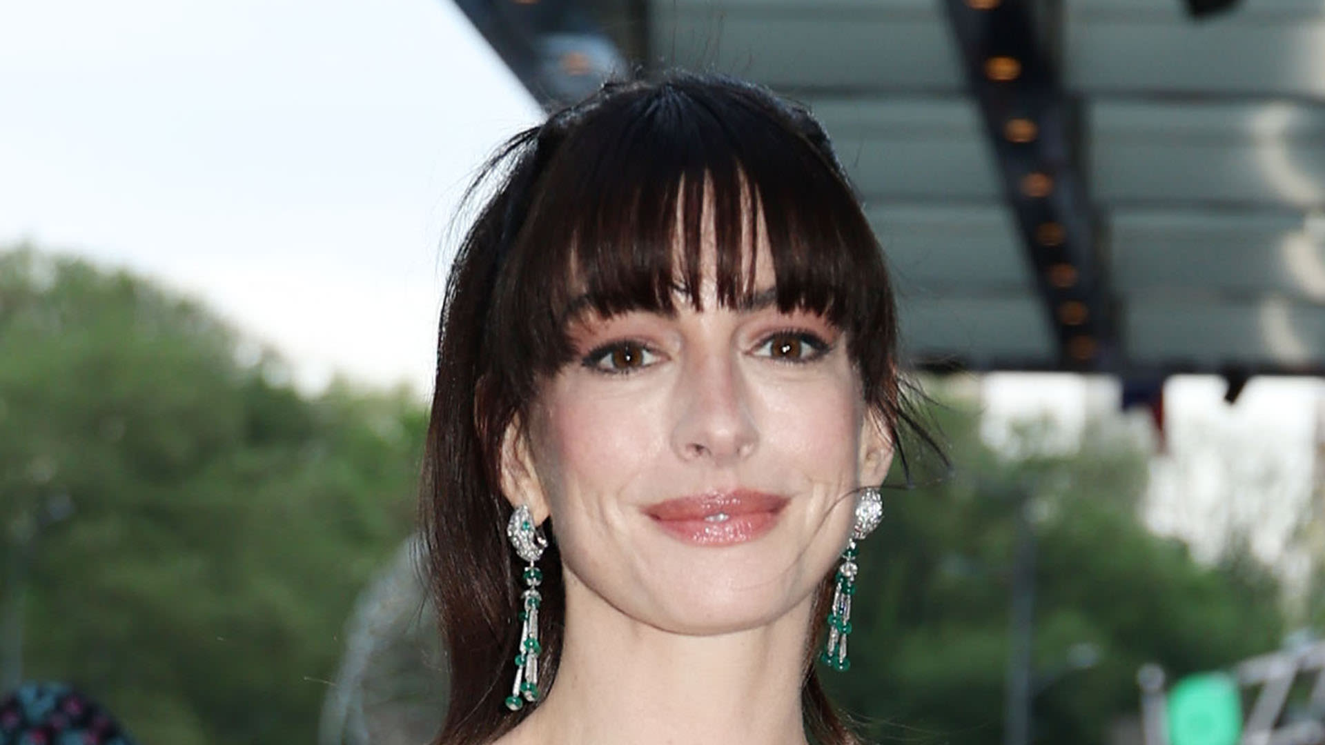 Anne Hathaway wears tight red dress as she attends The Idea of You premiere