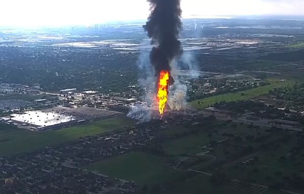 A pipeline explosion is shooting a towering pillar of flame over a Houston suburb