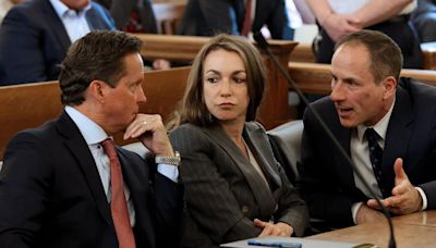 ... Police Officer John O'Keefe, talks with her attorney's Alan Jackson and David Yannetti as she attends a hearing in Norfolk Superior Court...
