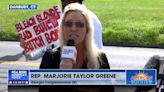 Marjorie Taylor Greene rages outside Bannon’s prison - but is interrupted by a ‘Bleach Blonde Bad Built Butch Body’ sign