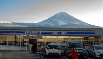 A Japanese town will erect a large mesh barrier to stop negligent foreign tourists from taking photos of Mount Fuji