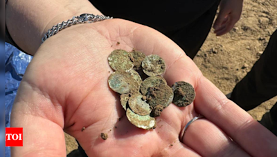 'Once-in-a-decade discovery': Woman finds over 2,150 ancient silver coins while out on a walk - Times of India
