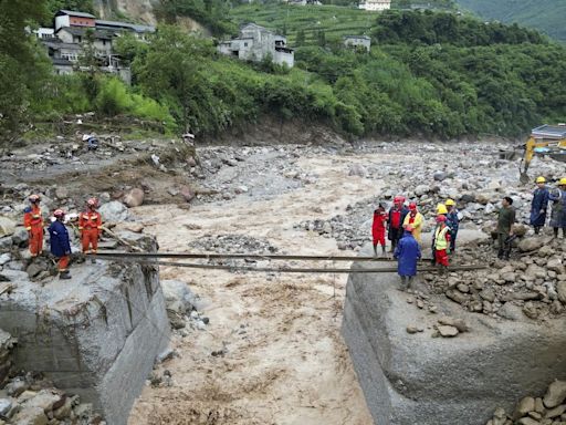 Rescuers search for dozens missing after flooding and a bridge collapse in China kill at least 25