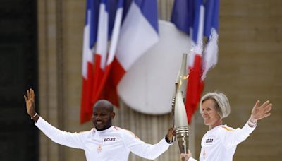 Olympic torch relay works its way past Paris landmarks in buildup to Games
