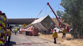 Tow crews use large airbags to flip overturned semi