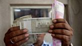 Rupee slips to record low as equity sentiment sours after tax hike