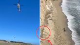 A kite surfer stranded on a remote California beach was rescued after he used rocks to spell 'HELP' on the sand