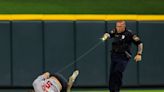 Use of force being investigated in arrest of fan who crashed Reds game, police say