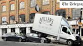 Pictured: Crumpled bakery van sandwiched between lamppost and two cars after crash