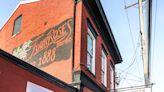 Shepard Fairey paints OBEY painting on side of Louisville bar