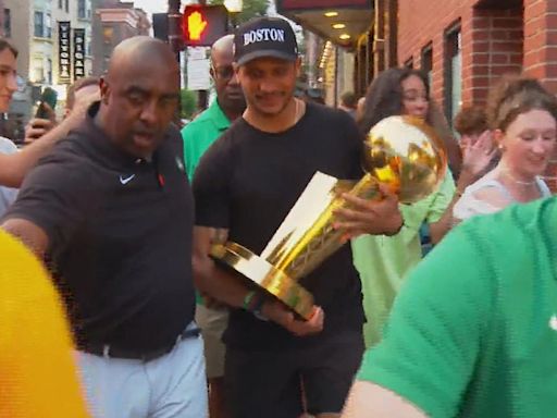 Celtics coach Joe Mazzulla takes championship trophy around North End