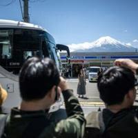 Japan town begins blocking Mt Fuji view from 'bad-mannered' tourists