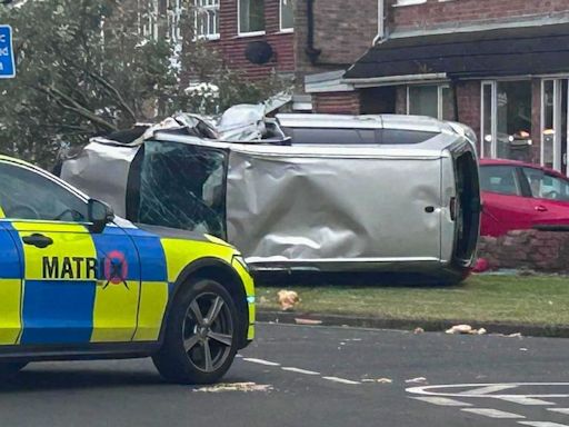 Flipped car brings down tree and comes to a stop outside home as dramatic pictures show near miss