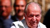 Juan Carlos met by cheering crowd and political embarrassment on return to Spain