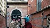 A demonstrator jumps over a barricade next to a University of Amsterdam building on the Binnengasthuis building grounds, during an occupation by pro-Palestinian students -- similar protests have occurred worldwide