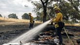 Wind-driven wildfire spreads outside a central Oregon community and prompts evacuations