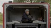 Oleksandr, an evacuee from the frontline village of Lyptsi arrives in an armoured vehicle at a checkpoint