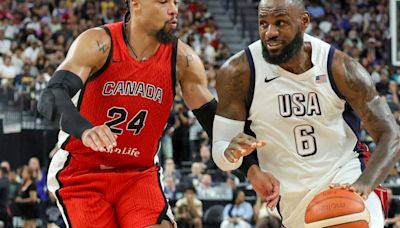 The United States' LeBron James drives against Canada's Dillon Brooks in the second half of an exhibition game ahead of the Paris Olympic Games, at T-...