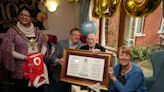 Wartime hero who saved famed building grins as he is honoured on 100th birthday