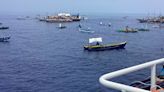 About 100 Filipino activists and fishermen sail on wooden boats to disputed shoal guarded by China