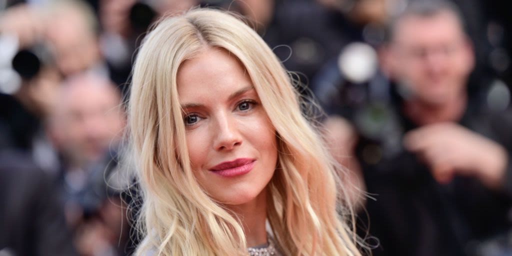 Sienna Miller is a boho vision in white detailed lace top and tiny shorts