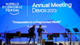 As elites arrive in Davos, conspiracy theories thrive online