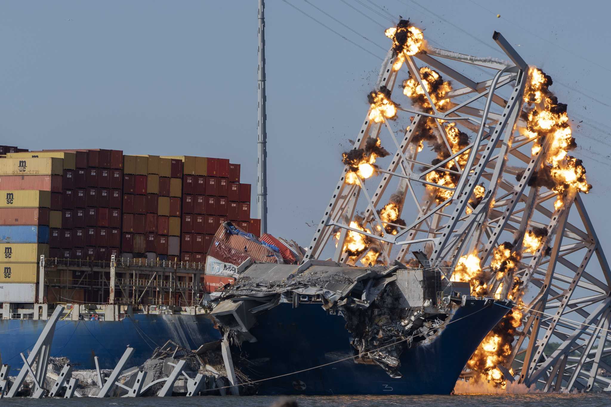 Collapsed Baltimore bridge span comes down with a boom after crews set off chain of explosives