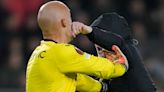 Sevilla goalkeeper Marko Dmitrovic attacked by pitch invader in PSV clash