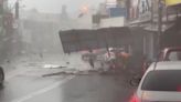 Debris blown down road as Typhoon Koinu brings violent, record-breaking winds to Taiwan